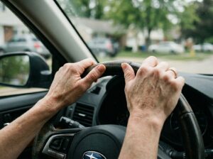 mom gripping steering wheel overwhelmed in parked car