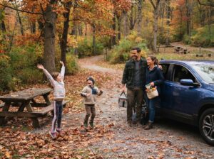 Kids stretching at a fall road trip stop